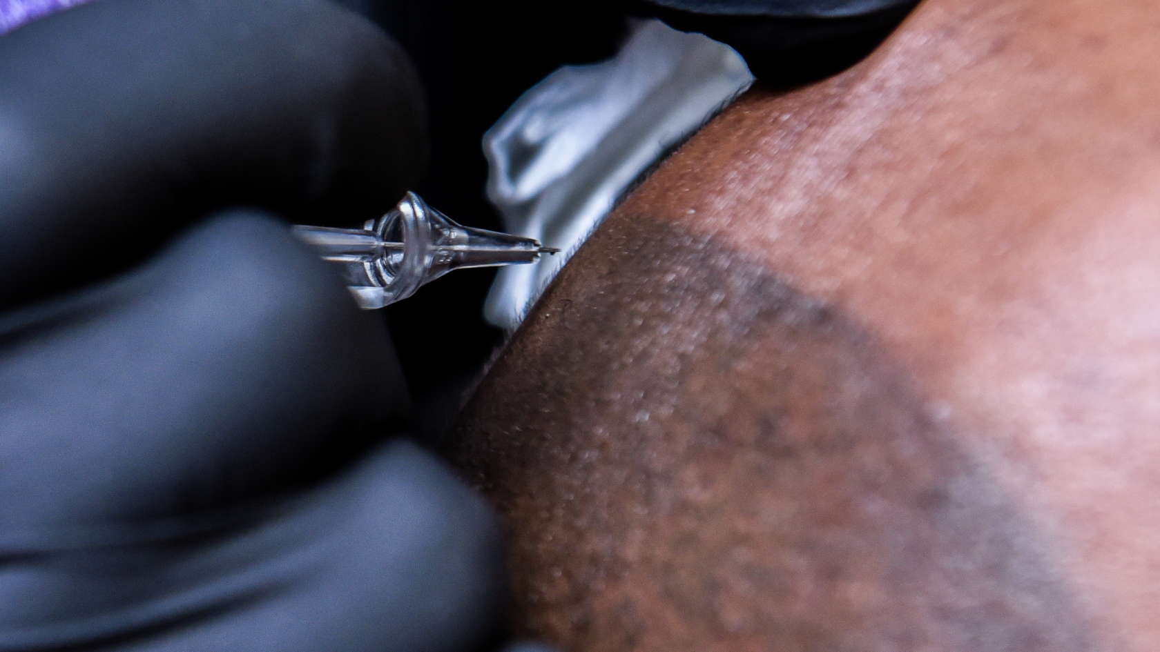 A close up of a person's arm with a ring on it