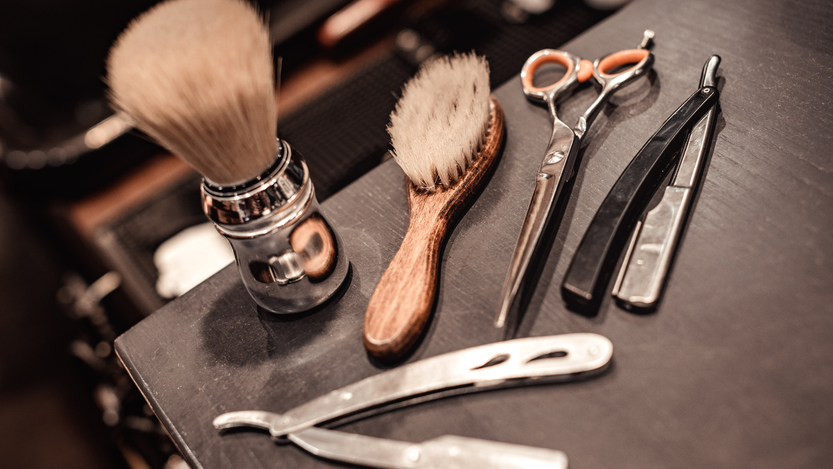 A close up of a shaving brush, scissors and a razor